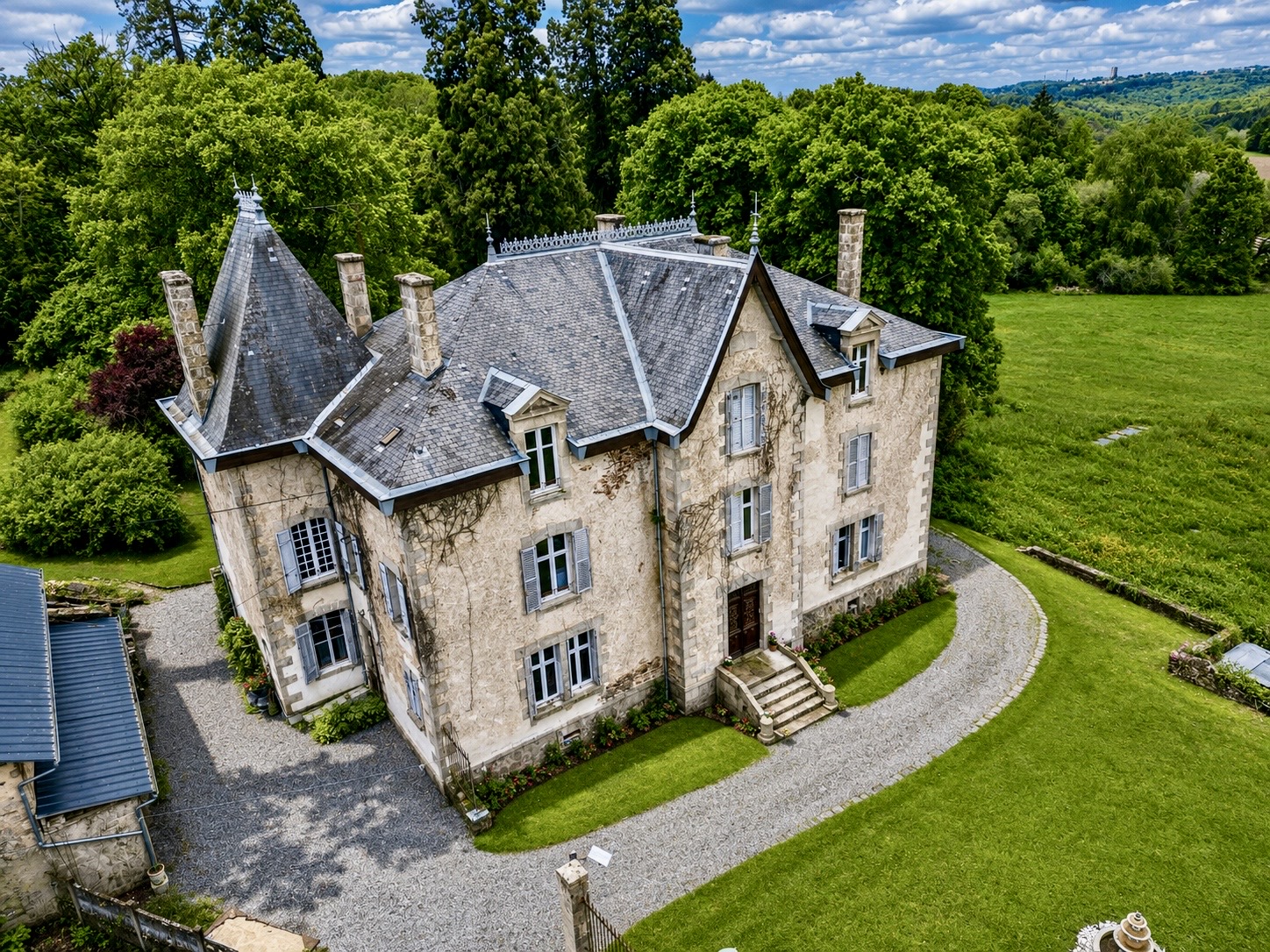 Château Mas Levrault seen from above, surrounded by mature trees and meadows